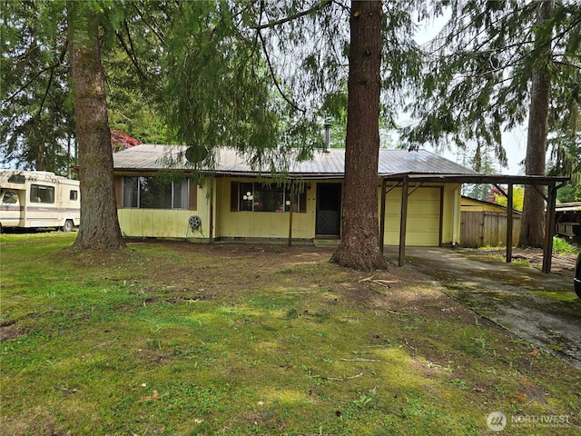 view of front of property with a carport, concrete driveway, metal roof, and an attached garage