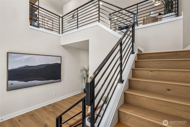 20304 154th St E Unit 15, Bonney Lake, WA 98391 - stairway featuring a towering ceiling, wood finished floors, and baseboards