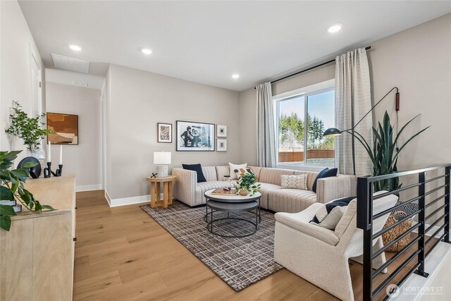 20304 154th St E Unit 15, Bonney Lake, WA 98391 - living room featuring light wood-style floors, baseboards, and recessed lighting