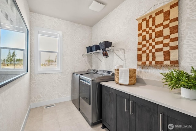 20304 154th St E Unit 15, Bonney Lake, WA 98391 - laundry area featuring independent washer and dryer, cabinet space, baseboards, and light tile patterned floors