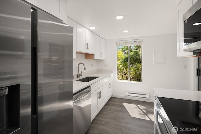 17537 151st Ave SE Unit 9-4, Renton, WA 98058 - kitchen featuring appliances with stainless steel finishes, a sink, a baseboard heating unit, recessed lighting, and white cabinets