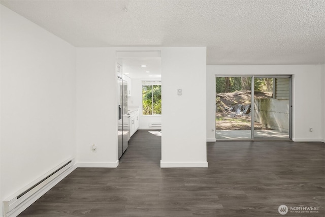 17537 151st Ave SE Unit 9-4, Renton, WA 98058 - spare room with baseboard heating, dark wood finished floors, a baseboard heating unit, baseboards, and a textured ceiling
