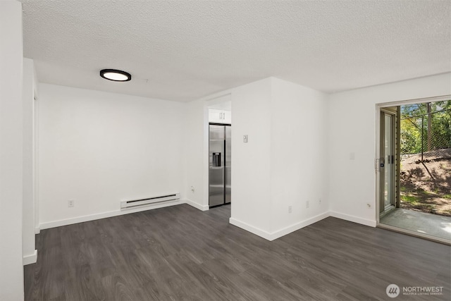 17537 151st Ave SE Unit 9-4, Renton, WA 98058 - unfurnished room featuring a baseboard heating unit, dark wood-type flooring, a textured ceiling, and baseboards