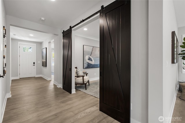 15321 204th Ave E Unit 56, Bonney Lake, WA 98391 - entrance foyer featuring a barn door, light wood-style flooring, baseboards, and recessed lighting