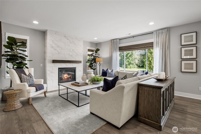 15321 204th Ave E Unit 56, Bonney Lake, WA 98391 - living room featuring dark wood-style floors, a tiled fireplace, baseboards, and recessed lighting