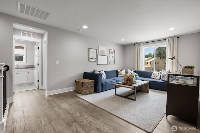 15321 204th Ave E Unit 56, Bonney Lake, WA 98391 - living area featuring light wood-style flooring, recessed lighting, and baseboards