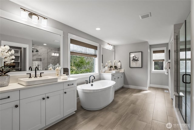 15321 204th Ave E Unit 56, Bonney Lake, WA 98391 - bathroom with a stall shower, plenty of natural light, two vanities, and baseboards
