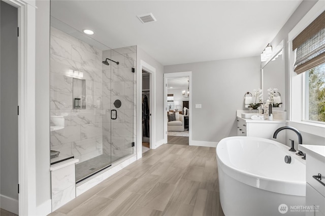 15321 204th Ave E Unit 56, Bonney Lake, WA 98391 - bathroom featuring a shower stall, baseboards, vanity, a soaking tub, and recessed lighting
