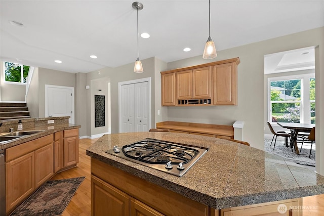 kitchen featuring appliances with stainless steel finishes, tile countertops, a sink, plenty of natural light, and recessed lighting