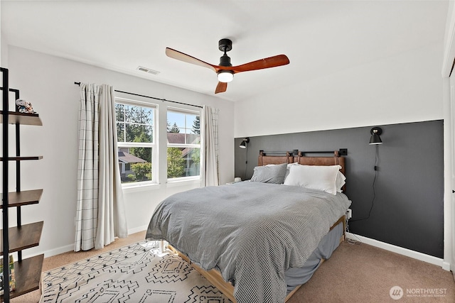 bedroom featuring light carpet, baseboards, and a ceiling fan