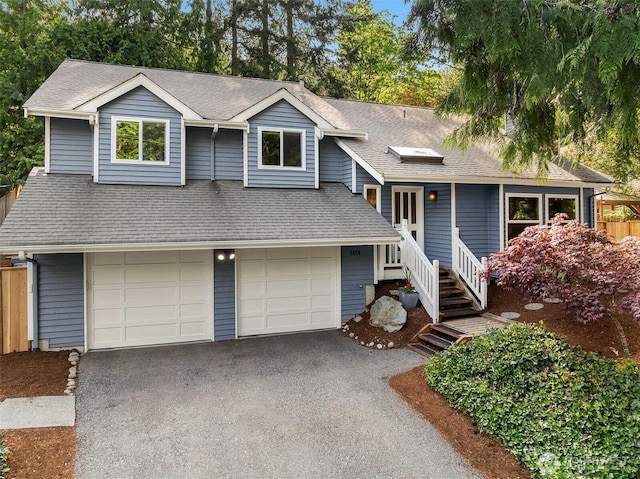 1020 Greenwood Blvd SW, Issaquah, WA 98027 - view of front facade with driveway, an attached garage, roof with shingles, and fence