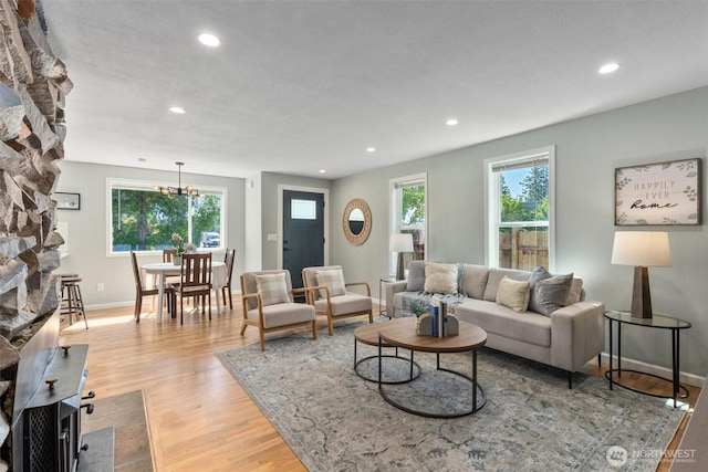 8155 28th Ave SW, Seattle, WA 98126 - living area with light wood-style flooring, recessed lighting, a chandelier, and baseboards