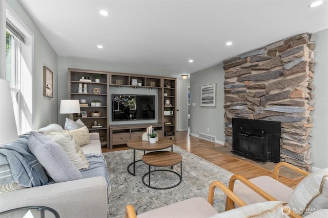 8155 28th Ave SW, Seattle, WA 98126 - living room with wood finished floors, recessed lighting, a fireplace, and baseboards
