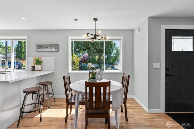 8155 28th Ave SW, Seattle, WA 98126 - dining area with a chandelier, light wood-type flooring, baseboards, and recessed lighting