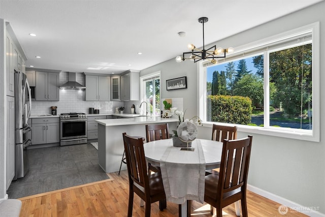 8155 28th Ave SW, Seattle, WA 98126 - dining area featuring a chandelier, wood finished floors, recessed lighting, and baseboards