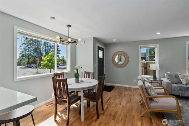 8155 28th Ave SW, Seattle, WA 98126 - dining space with healthy amount of natural light, a chandelier, light wood-style floors, and recessed lighting