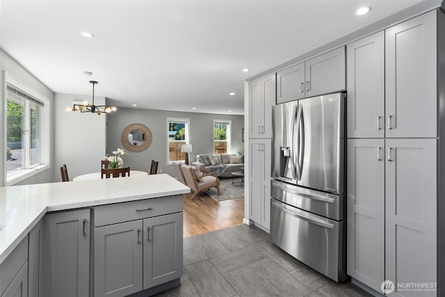8155 28th Ave SW, Seattle, WA 98126 - kitchen with stainless steel fridge with ice dispenser, gray cabinetry, a chandelier, recessed lighting, and hanging light fixtures