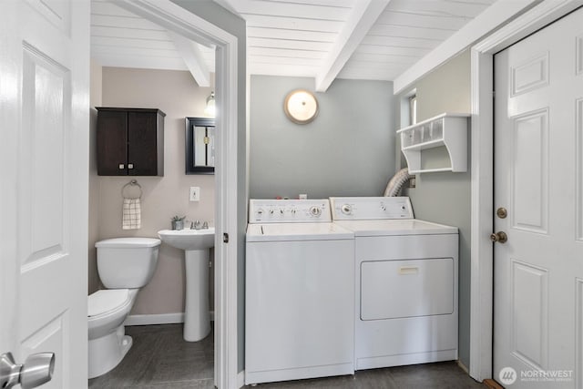 8155 28th Ave SW, Seattle, WA 98126 - laundry room with washer and clothes dryer, wood ceiling, and baseboards
