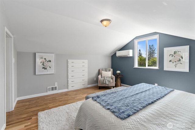 8155 28th Ave SW, Seattle, WA 98126 - bedroom with a wall unit AC, wood finished floors, lofted ceiling, and baseboards