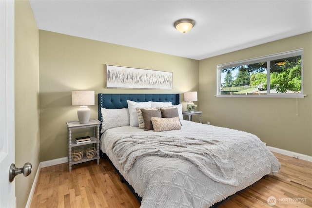 8155 28th Ave SW, Seattle, WA 98126 - bedroom featuring baseboards and wood finished floors