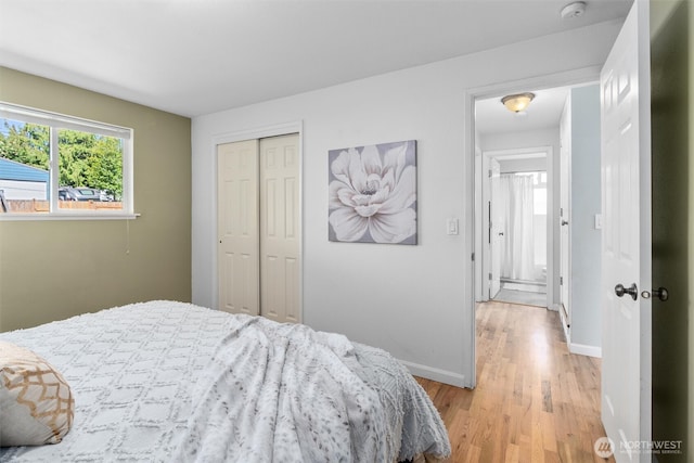 8155 28th Ave SW, Seattle, WA 98126 - bedroom featuring baseboards, light wood-style floors, and a closet
