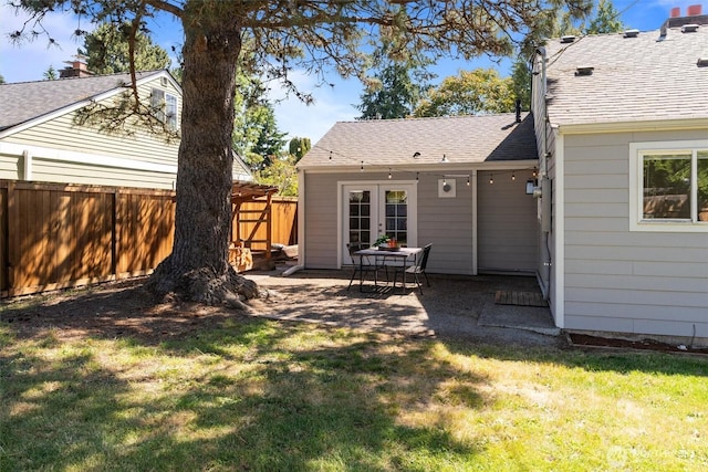 8155 28th Ave SW, Seattle, WA 98126 - rear view of house with french doors, a patio, and roof with shingles