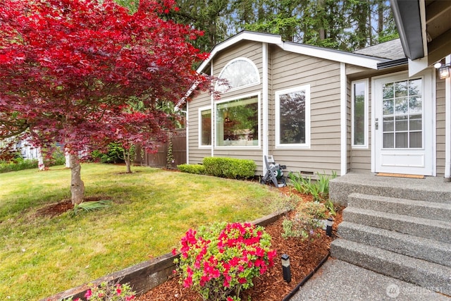 view of home's exterior with a lawn and crawl space