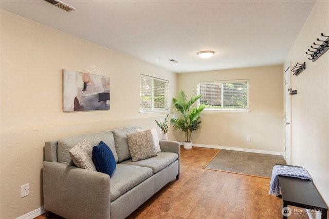 living area featuring wood finished floors and baseboards