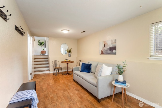 living area with light wood finished floors, stairs, and baseboards