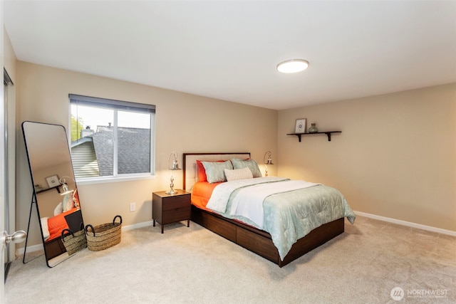 bedroom featuring carpet and baseboards