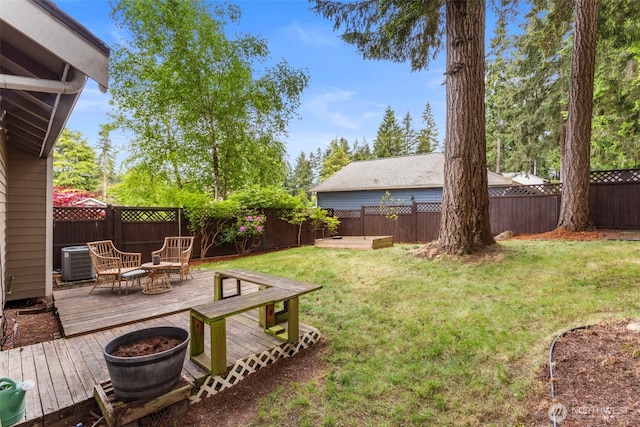 view of yard featuring a deck and central air condition unit