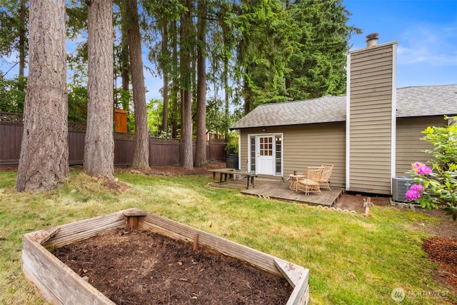 view of yard with central AC and a patio