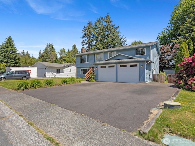 17417 29th Dr SE, Bothell, WA 98012 - view of front of home with a chimney, asphalt driveway, and a garage