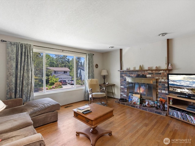 17417 29th Dr SE, Bothell, WA 98012 - living room with a fireplace, wood finished floors, and a textured ceiling