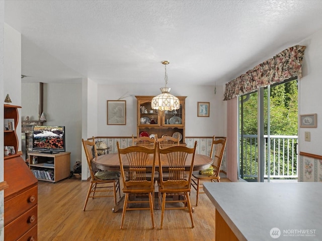 17417 29th Dr SE, Bothell, WA 98012 - dining room with light wood-style floors, a chandelier, and a textured ceiling