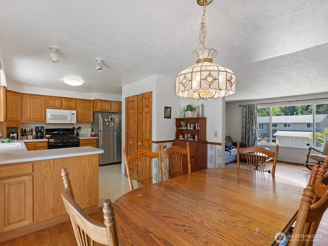 17417 29th Dr SE, Bothell, WA 98012 - dining space with a textured ceiling and light wood-style flooring