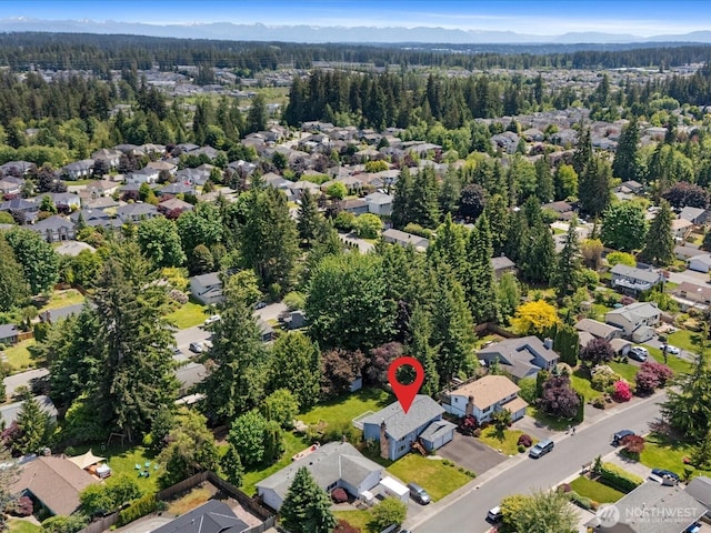 17417 29th Dr SE, Bothell, WA 98012 - aerial view of property's location with a forest, nearby suburban area, and a mountainous background