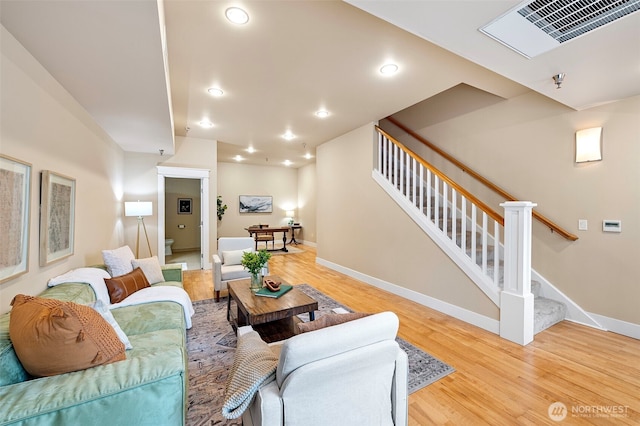 708 Market St Unit 409, Tacoma, WA 98402 - living area with wood finished floors, stairs, baseboards, and recessed lighting