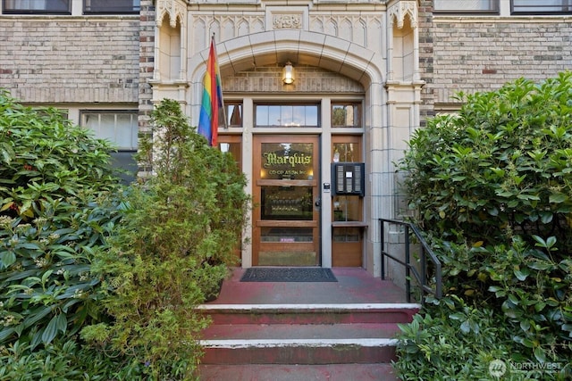 property entrance featuring brick siding and stone siding