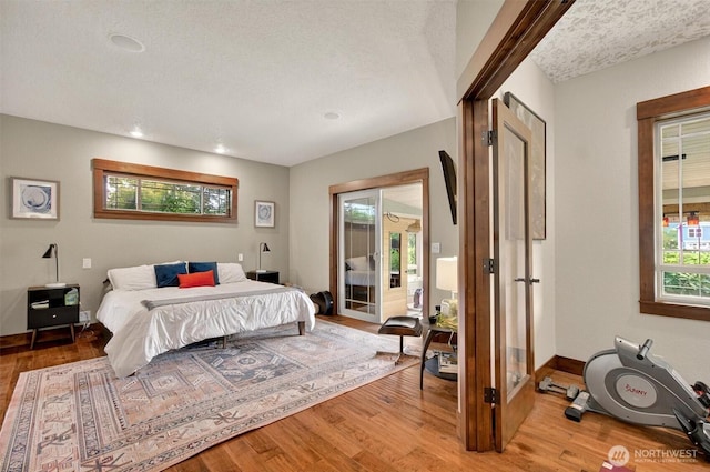 45 N Welcome Slough Rd, Cathlamet, WA 98612 - bedroom featuring wood finished floors, access to outside, baseboards, and a textured ceiling