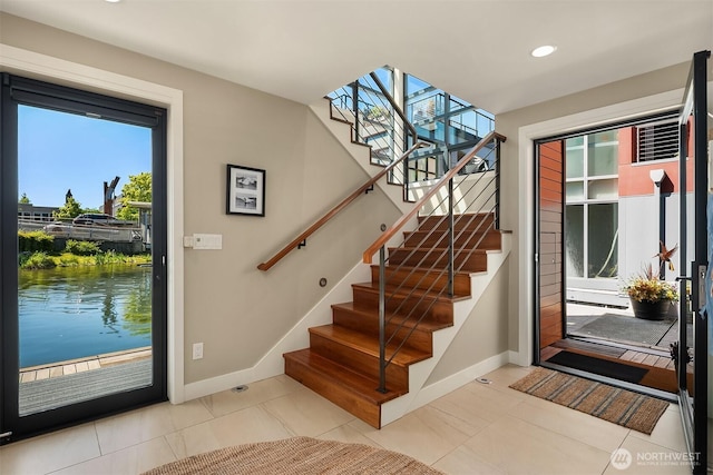 2821 Fairview Ave E Unit 5, Seattle, WA 98102 - foyer entrance featuring baseboards, stairway, tile patterned floors, and recessed lighting