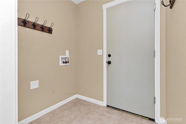 laundry area featuring hookup for a washing machine, light tile patterned floors, and baseboards