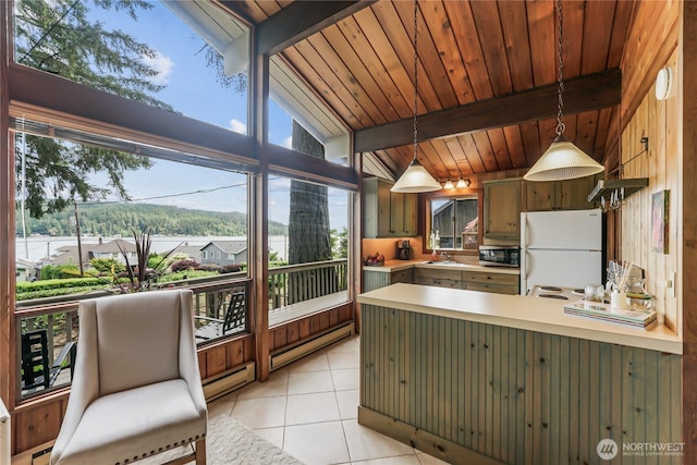 8310 E State Route 106, Union, WA 98592 - kitchen featuring freestanding refrigerator, a baseboard radiator, light tile patterned flooring, a peninsula, and a baseboard heating unit