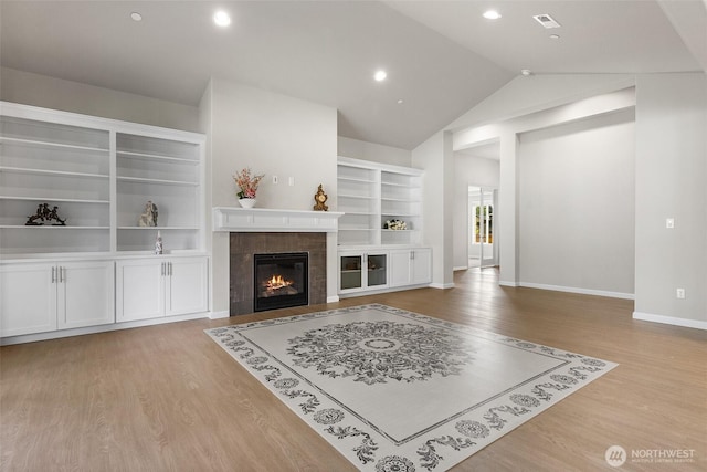 1803 135th Street Ct S, Tacoma, WA 98444 - living area featuring wood finished floors, a fireplace, lofted ceiling, baseboards, and built in shelves