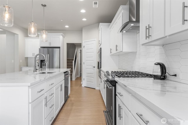 1803 135th Street Ct S, Tacoma, WA 98444 - kitchen with wall chimney range hood, stainless steel appliances, a sink, recessed lighting, and backsplash