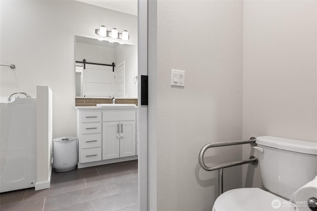 1803 135th Street Ct S, Tacoma, WA 98444 - bathroom featuring tile patterned floors, toilet, vanity, and baseboards