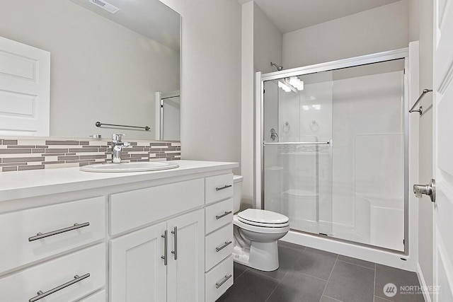 1803 135th Street Ct S, Tacoma, WA 98444 - bathroom featuring tile patterned floors, decorative backsplash, toilet, and a stall shower