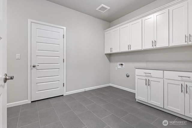 1803 135th Street Ct S, Tacoma, WA 98444 - clothes washing area with cabinet space, washer hookup, dark tile patterned floors, and baseboards