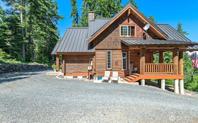 20 Skull Springs Rd, Cle Elum, WA 98922 - view of front of house featuring a standing seam roof, metal roof, log siding, and a chimney