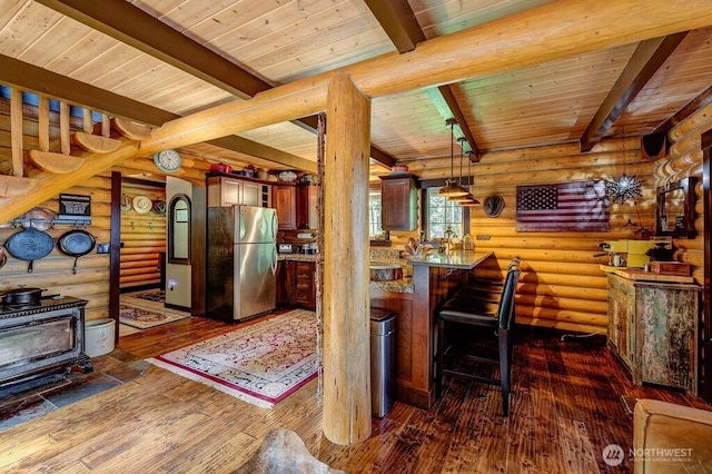 20 Skull Springs Rd, Cle Elum, WA 98922 - kitchen featuring freestanding refrigerator, wooden ceiling, beam ceiling, a wood stove, and dark wood finished floors